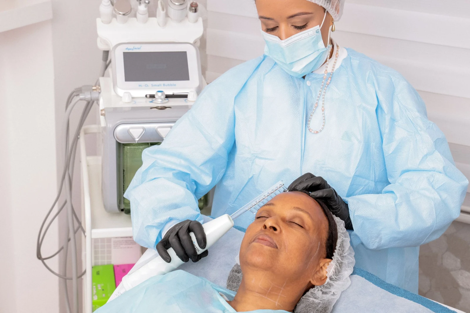 Practitioner performing a skincare treatment
