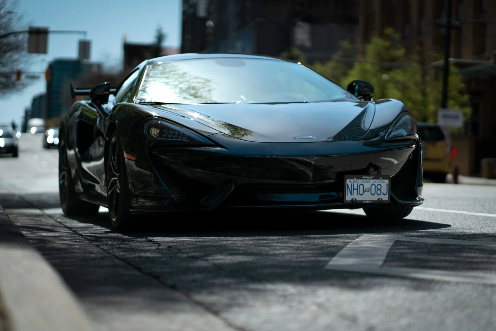 Black sports car on a city street