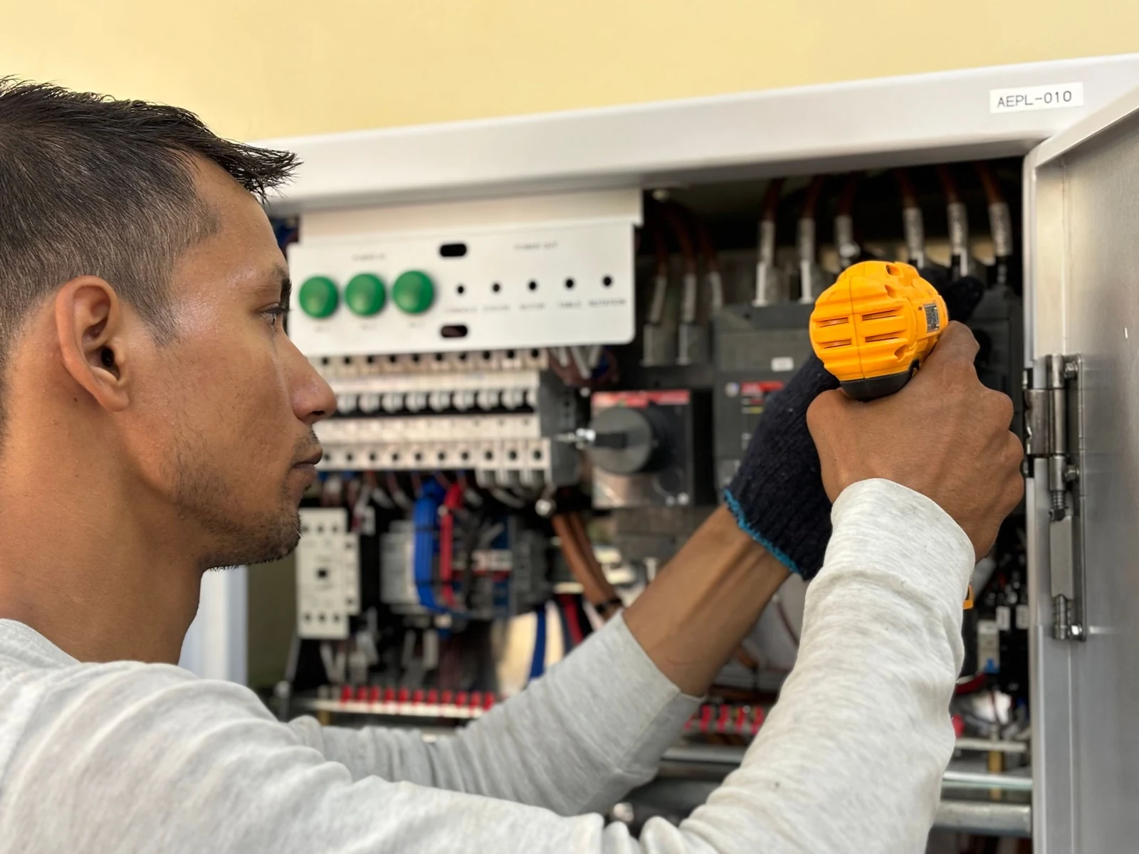 Electrician working on an electrical panel