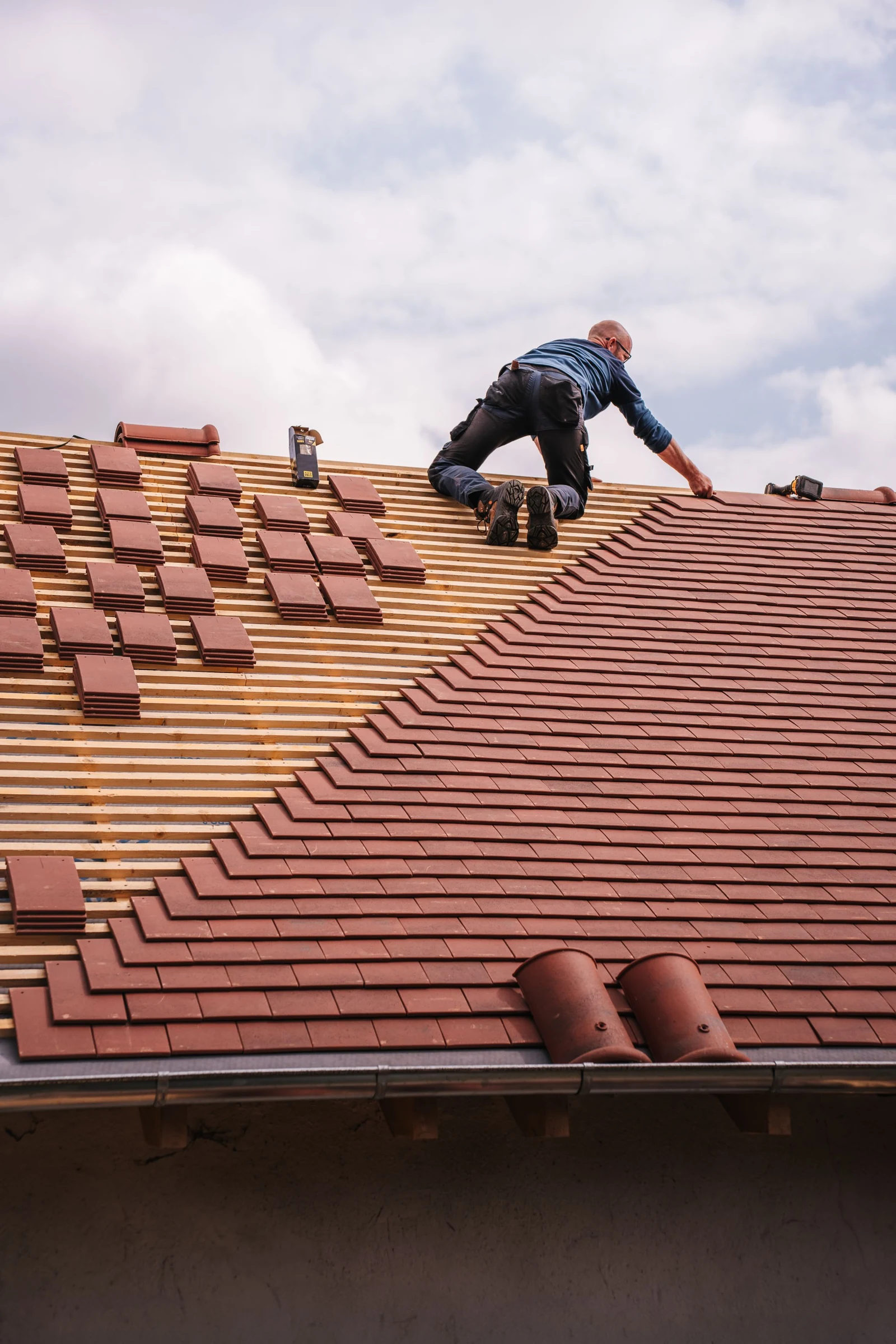 Roofer installing roof shingles